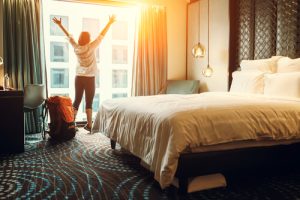 woman standing at window in hotel room