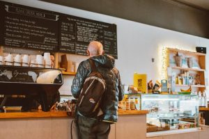 Man buying items in a cafe