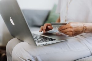 Person entering card details on to a laptop