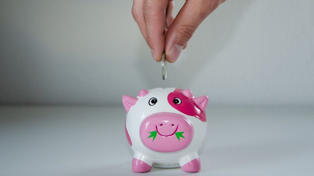 Putting money into a piggy bank
