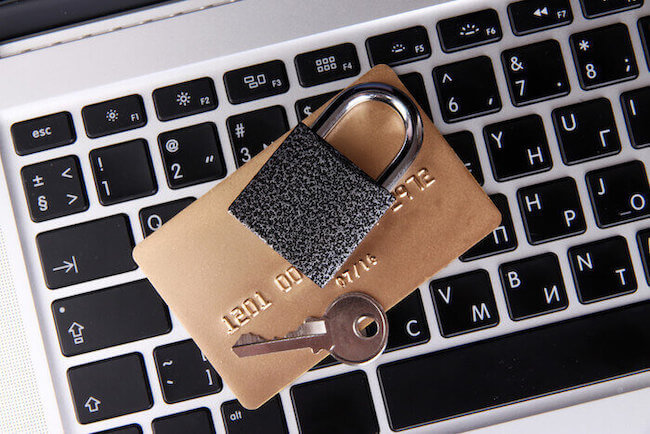 Padlock and key on top of payment card